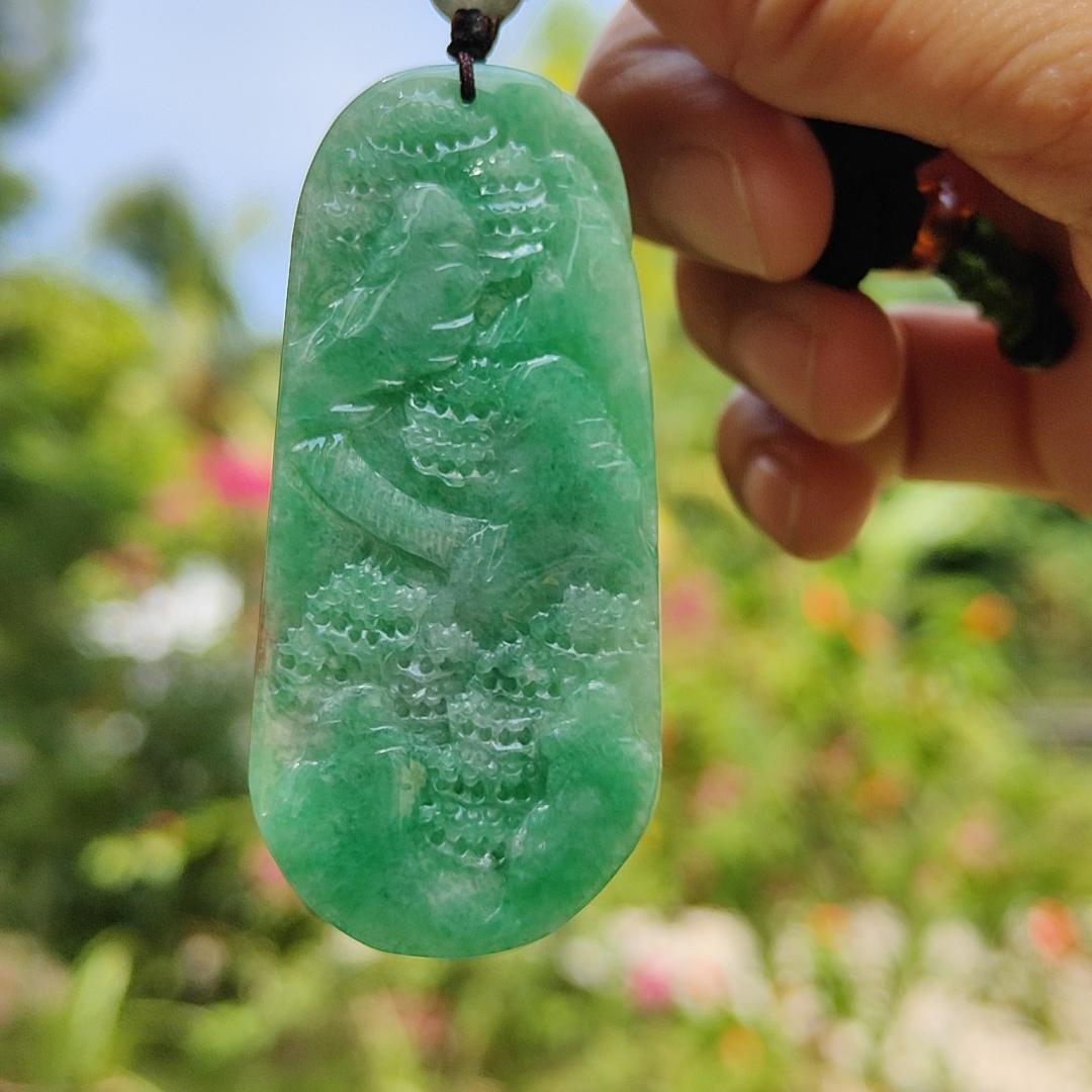 Green with patches of light brown Translucent Natural Type A Jadeite Pendant carved with scenery with NGI Gemstone report weight 126.07 grams, 60.73 * 27.79 * 9.53 mm , fine grain crystal aggregate, granular and fibrous interlocking texture (pendant142)