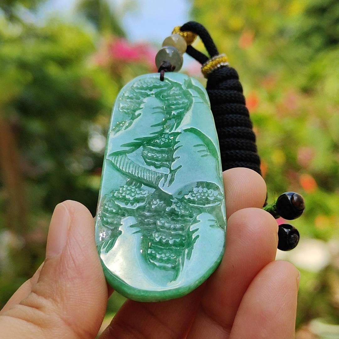 Green with patches of light brown Translucent Natural Type A Jadeite Pendant carved with scenery with NGI Gemstone report weight 126.07 grams, 60.73 * 27.79 * 9.53 mm , fine grain crystal aggregate, granular and fibrous interlocking texture (pendant142)