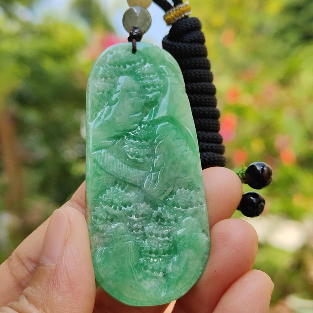 Green with patches of light brown Translucent Natural Type A Jadeite Pendant carved with scenery with NGI Gemstone report weight 126.07 grams, 60.73 * 27.79 * 9.53 mm , fine grain crystal aggregate, granular and fibrous interlocking texture (pendant142)