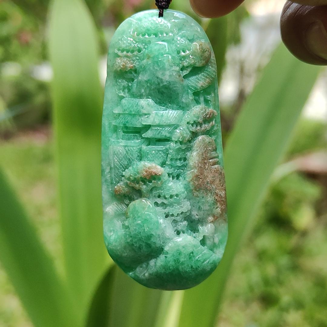 Green with patches of light brown Translucent Natural Type A Jadeite Pendant carved with scenery with NGI Gemstone report weight 126.07 grams, 60.73 * 27.79 * 9.53 mm , fine grain crystal aggregate, granular and fibrous interlocking texture (pendant142)