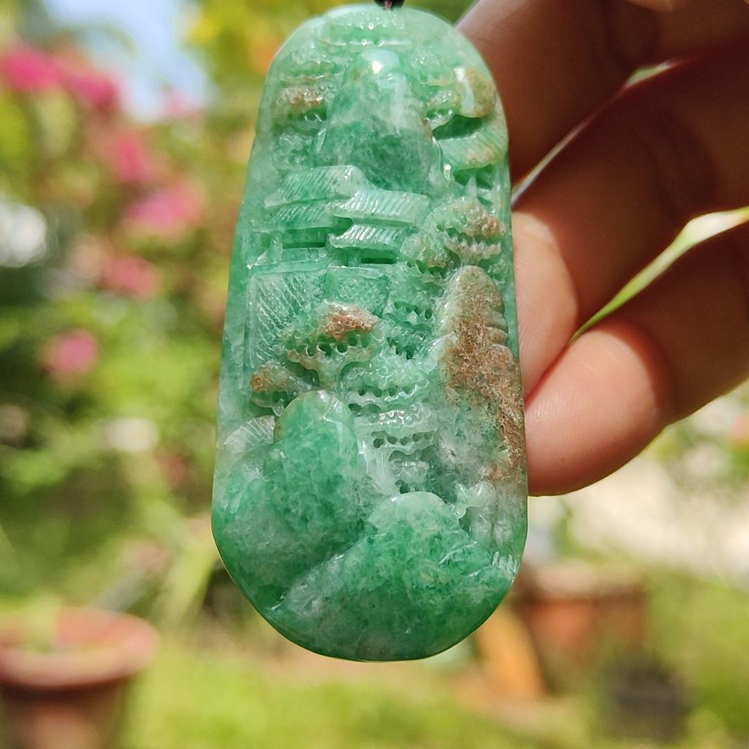 Green with patches of light brown Translucent Natural Type A Jadeite Pendant carved with scenery with NGI Gemstone report weight 126.07 grams, 60.73 * 27.79 * 9.53 mm , fine grain crystal aggregate, granular and fibrous interlocking texture (pendant142)